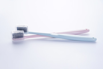 Two beautiful multi-colored toothbrushes with black shields, on a white background. Is isolated.