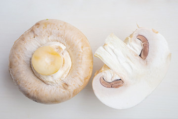Sliced and whole raw chapminons close-up, detailed macro photo. The concept of healthy food, vegetarianism, mushrooms.