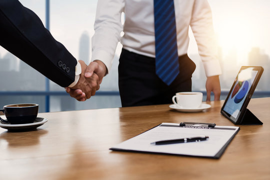successful negotiate and handshake concept, two businessman shake hand with parthner to celebration partnership and teamwork, business deal.