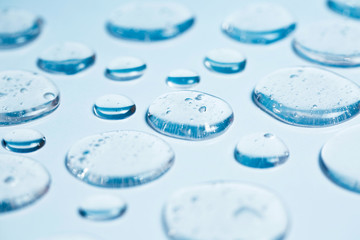 Gel drops forming background. Virus protection or cosmetics concept.