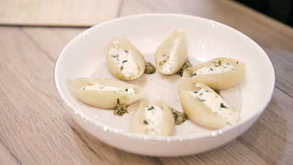 Chef serves a beautiful dish on a plate of Italian ravioli