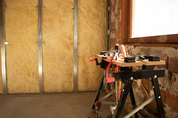 putting plasterboard on the wall preparation for insulation