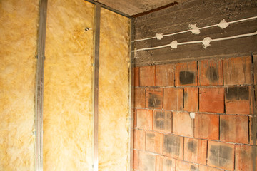 putting plasterboard on the wall preparation for insulation
