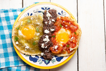 Mexican fried eggs with green and red sauce also called 