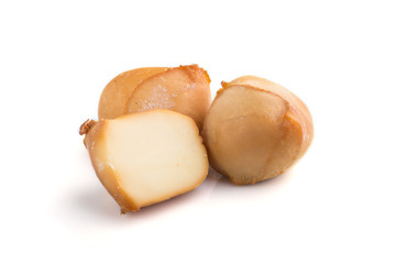 Piece of smoked cheese isolated on white background. Side view.