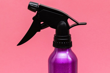 purple hair water sprayer, pulverizer on a pink background