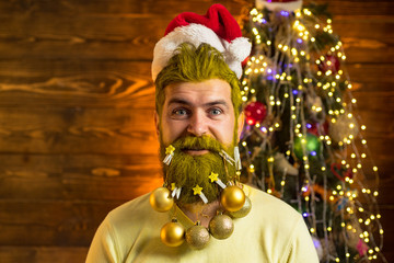 Portrait of handsome Santa man indoors with Christmas gift. New year Christmas concept. Portrait of a Santa Claus.