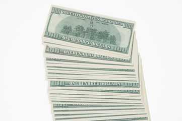 a stack of hundred dollar bills is fanned out in the middle of the image on a white background top view