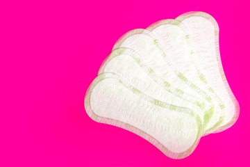 Women protection hygiene daily pads on pink background