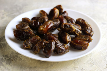 Dates from the Middle East on a white plate with a light background