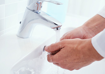 doctor man washing his hands in a sink
