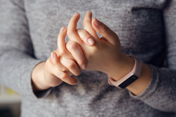 Close up on midsection of young caucasian woman female hands holding together crossed fingers in day
