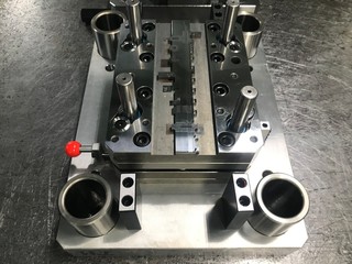 Sheet metal stamping tool die on the repair table. Progressive stamping system.At a high quality technology factory.