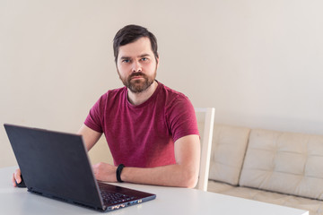 Men remote work from home behind laptop during epidemic in quarantine