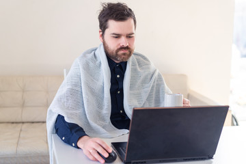 Men remote work from home behind laptop during epidemic under the rug