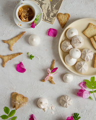 Fototapeta na wymiar Flatley on a light background: meringue, cookies and flowers.