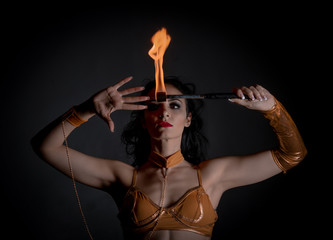 juggler girl performing fire games in dark atmosphere