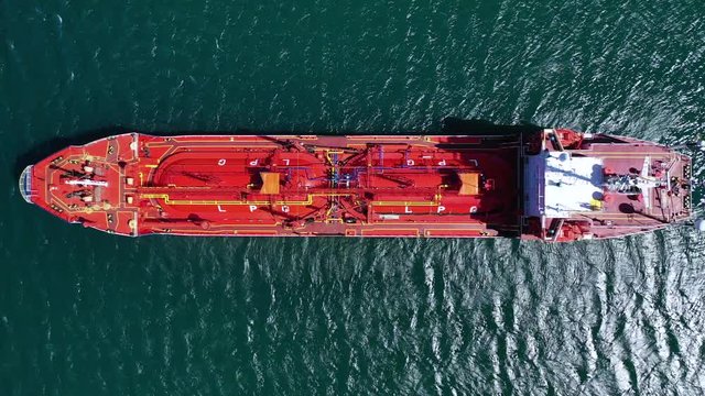 Aerial drone top down video of industrial LPG  gas tanker ship docked in Mediterranean deep blue sea