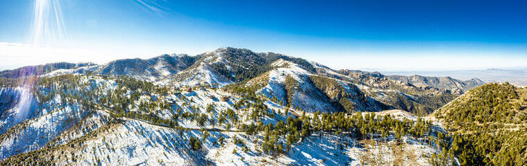 A panorama aerial image of the summit of Mt. Lemmon outside of Tucson, Arizona covered in snow with...