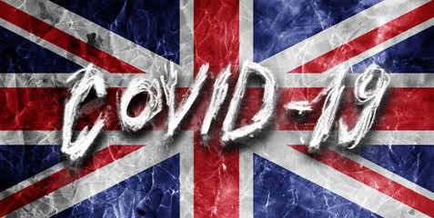 Grunge flag of United Kingdom with hand drawn Coronavirus name on it. 2019 - 2020 Novel Coronavirus (2019-nCoV) concept, for an outbreak occurs in UK.