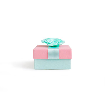 Beautiful gift box with ribbon isolated on white background. Bright mint and pink colors
