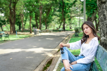  Beautiful Asian women with long hair wearing a white shirt. White bug hat, jeans showing emotions In the nature park-09.jpg, Asian beautiful woman with yellow skin, long black hair, wearing a white s