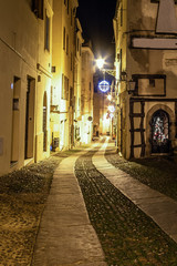 Paved street in old town Alghero by night