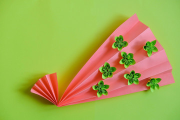 Paper origami flowers on bright background. Hobbies and free time. Copy space.