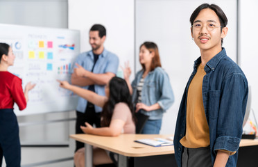 Smart asian startup small entrepreneur  standing confident portrait with  friends partner casual meeting brainstorm with white board and business financce paper chart anslysis in office background
