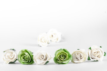 Obraz na płótnie Canvas Green and white roses on a white background, vintage style