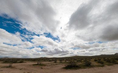 clouds over mountains in the mojave desert