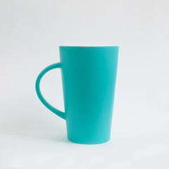 Tall turquoise cup isolated on white background