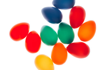 Multicolored Easter eggs on white background. Macro shot. Festive concept. Flat lay style.