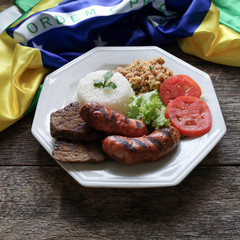 Brazilian food dish. Barbecue. Brazilian flag in the background.