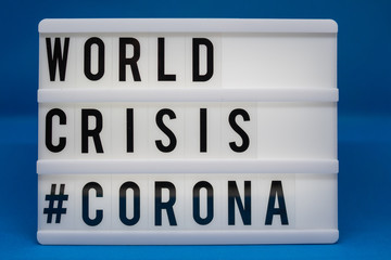 a light box with the inscription: WORLD CRISIS #CORONA