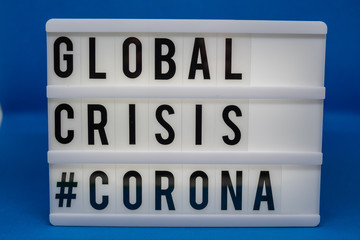 a light box with the inscription: GLOBAL CRISIS #CORONA