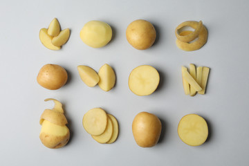 Flat lay with young potato on grey background, top view