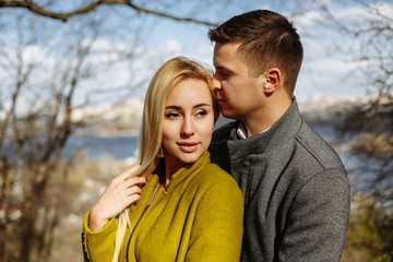 Fototapeta premium guy hugs a beautiful girl in the park