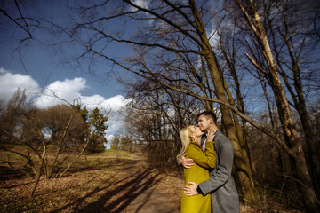 hugs of two lovers on the background of the park and sky