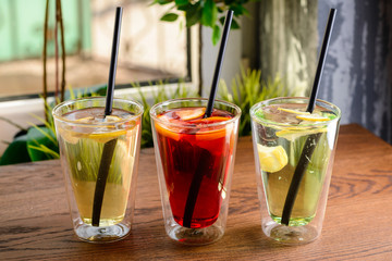 three homemade lemonade in a glass on a table