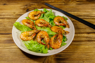 Tasty baked shrimps on a wooden table