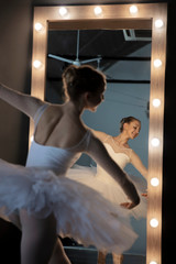 Elegant ballerina in white dress dancing in studio © BGStock72