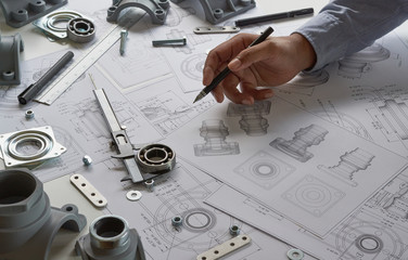 Engineer technician designing drawings mechanical parts engineering Engine.manufacturing factory...