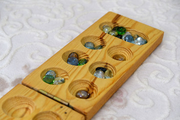 playing mancala at home, mancala intelligence game on carpet,