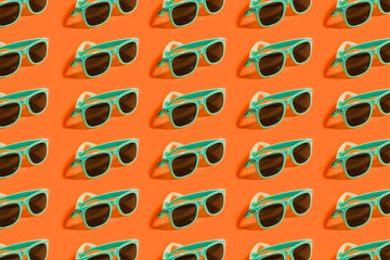 Cyan, aqua menthe sunglasses pattern isolated on background of lush lava color.
