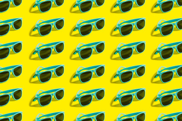 Cyan, aqua menthe sunglasses pattern isolated on background of yellow color.