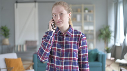 Fototapeta premium The Young Woman Standing And talking on Smart phone