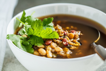 Vegetarian bean mix soup in a white bowl. Vegan food concept.