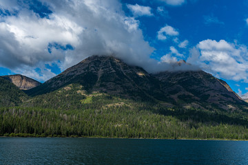 Obraz premium Cloud Covered Mountain and Waterton Lake