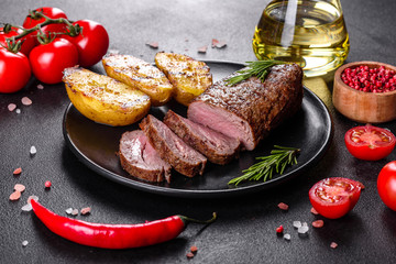 Ribeye steak with potatoes, onions and cherry tomatoes
